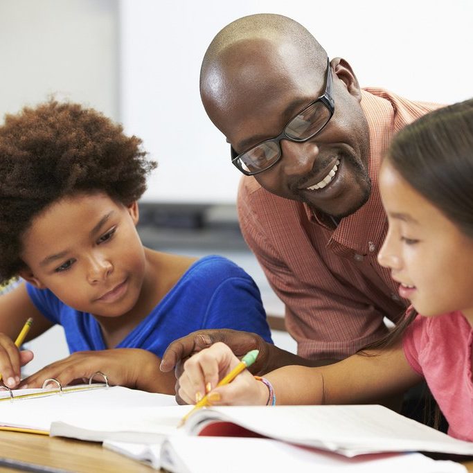 BlackMaleTeacher-2Girls_Writing_iStock-178471354_bzzt